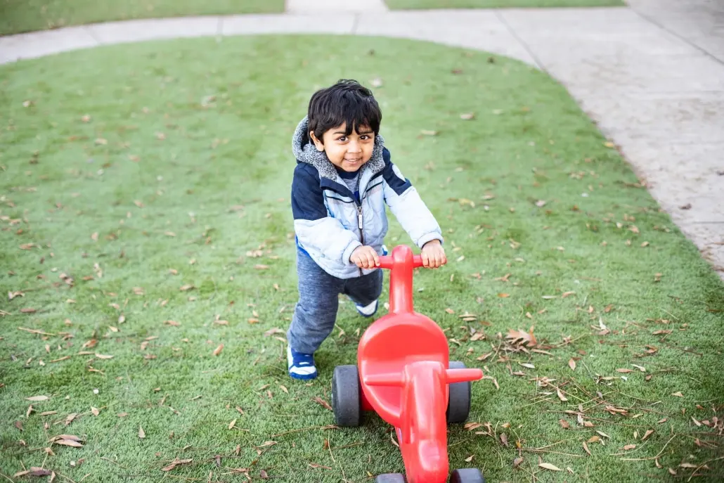 Little kid playing in the grass