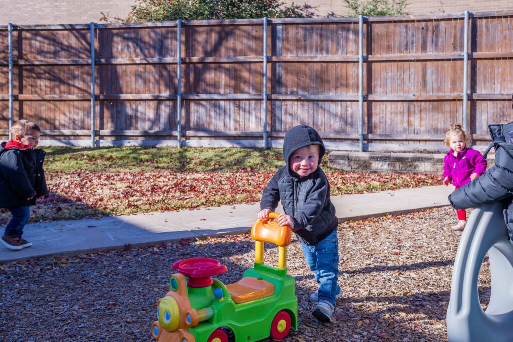 Kid Pushing His Bicycle